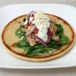 Greek chicken gyro topped with homemade Tzatziki sauce