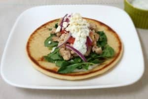 Greek chicken gyro topped with homemade Tzatziki sauce