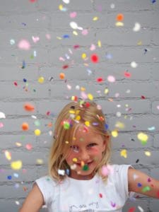 kid throwing confetti for babysitter
