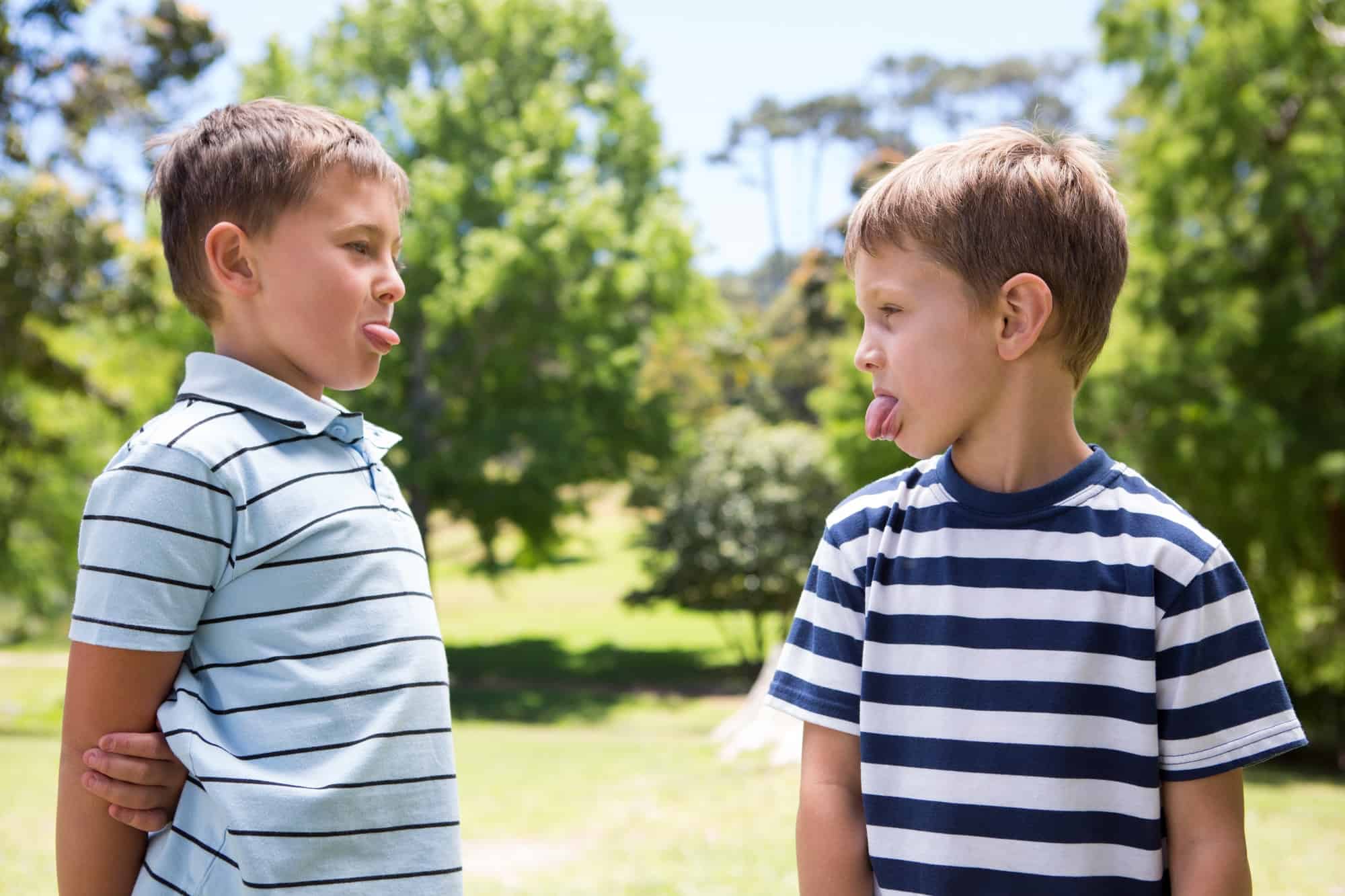 Two brothers engaged in a sticking out their tongue war. Discover 4 simple strategies to end sibling rivalry for good. And for more parenting tips and kid inspiration, follow Made In A Pinch on Pinterest!