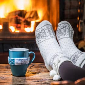 relaxing with a hot drink by the fire