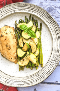 sheet pan roasted chicken and summer veggies on a plate