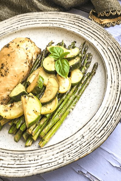 sheet pan roasted chicken and summer veggies on a plate