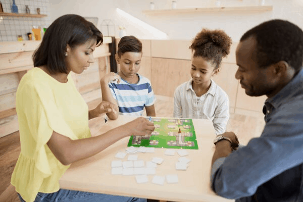 A list of the highest-rated, best board games for families to help you choose what to play on your next family game night!