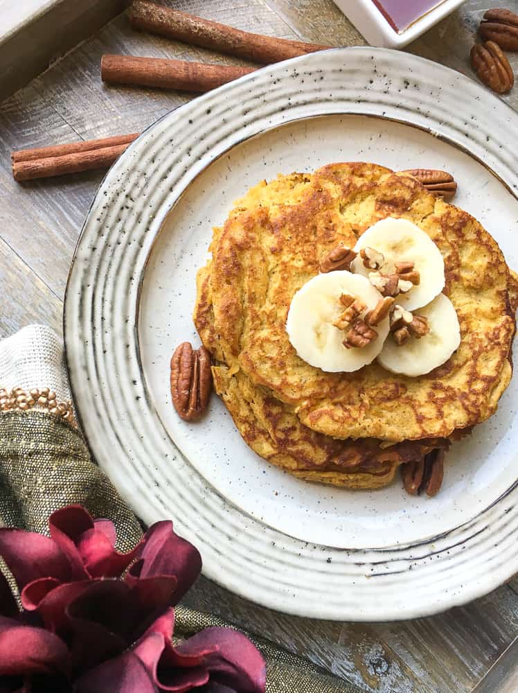 easy gluten-free, paleo-friendly pancakes topped with banana slices and nuts