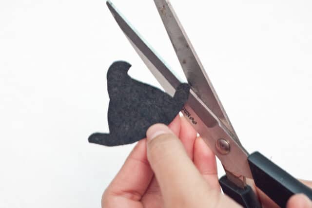 Witch Halloween bookmarks craft for kids tutorial, cutting the witch's hat out of black felt