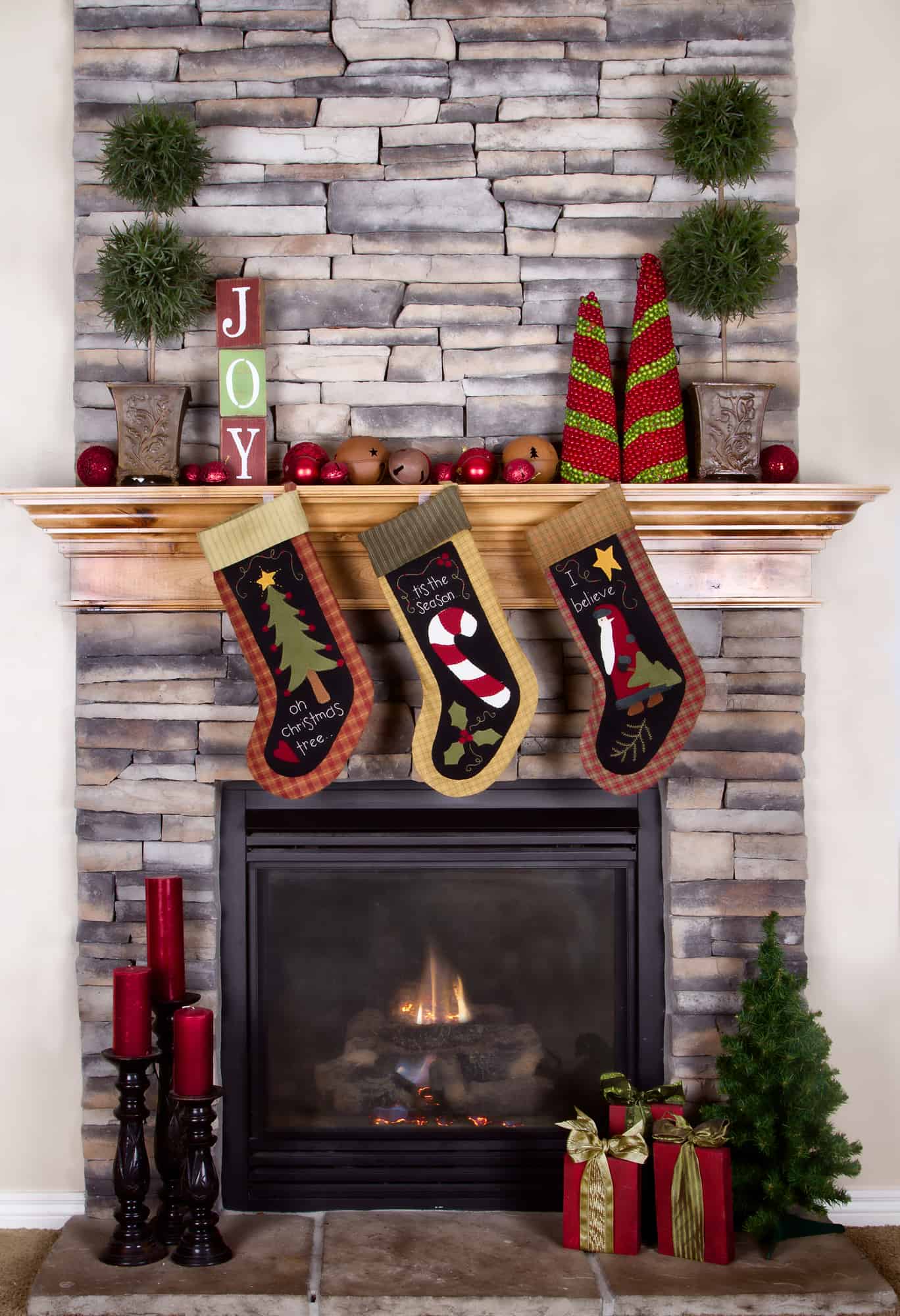Adding a festive touch like stockings and decorations around a fireplace mantle is one of 9 hacks for how to prepare your home for holiday guests