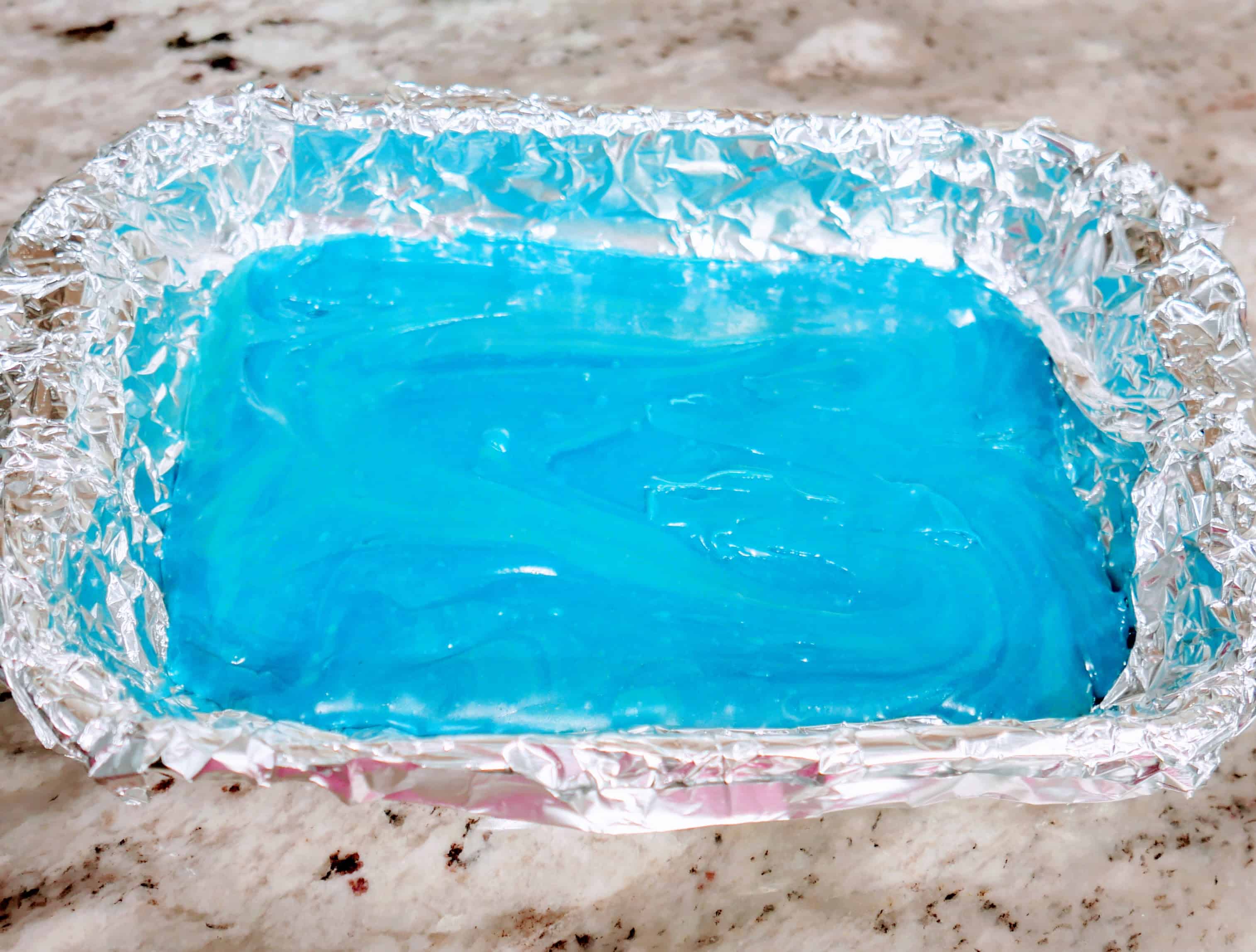 spread blue fudge mixture into a foil-lined glass baking dish