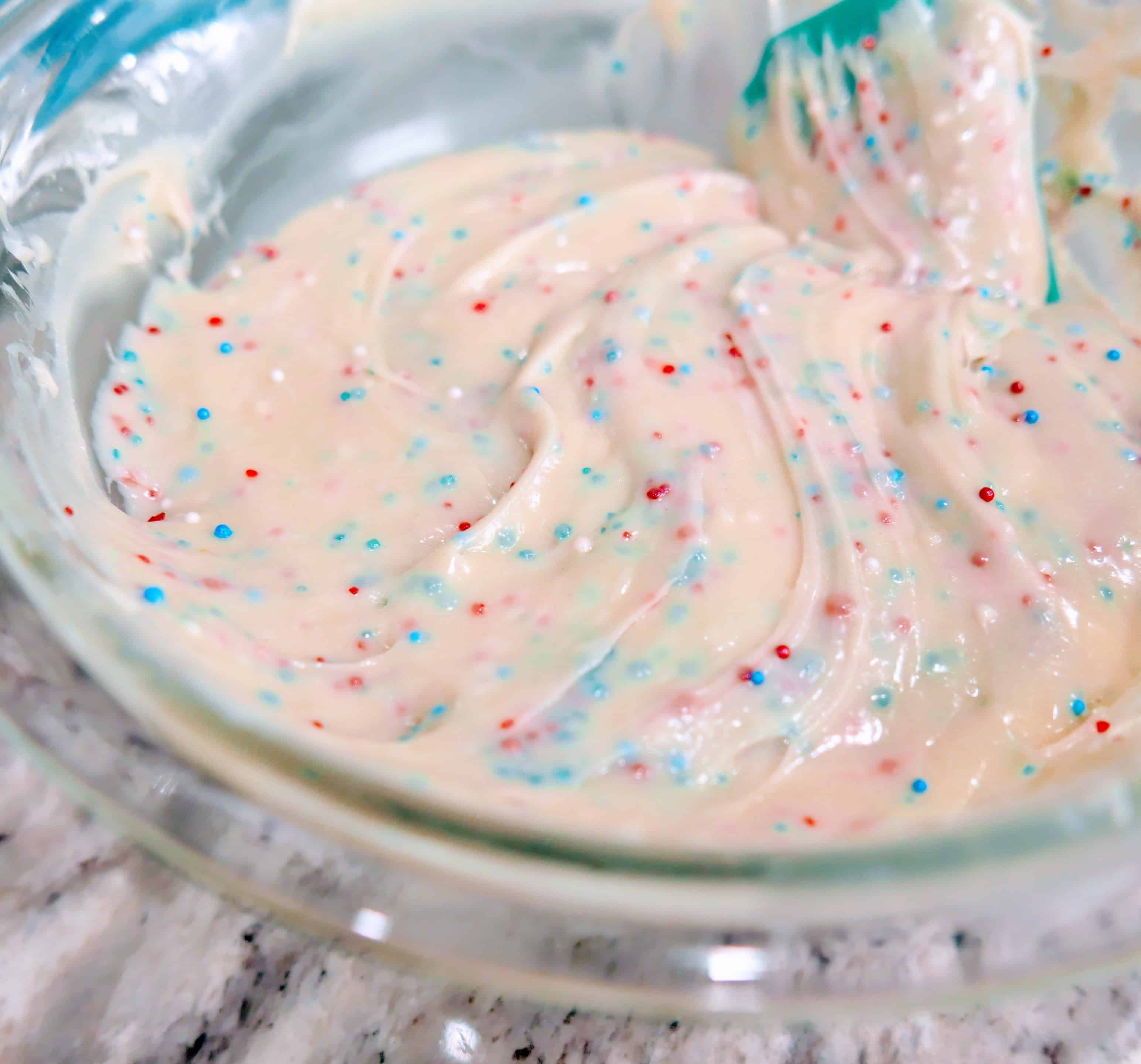 folding in colored sprinkles into fudge recipe ingredients