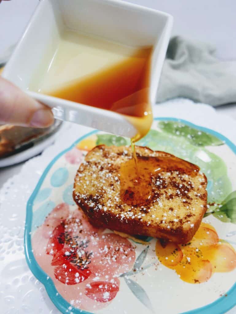 close up of pouring syrup onto a slice of pumpkin french toast