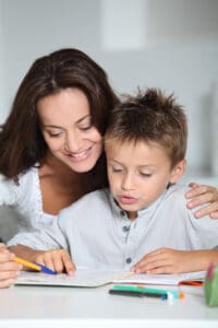 mom helping her son with his distance learning assignment