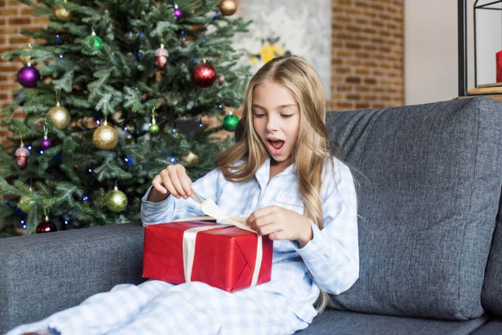 girl opening holiday present