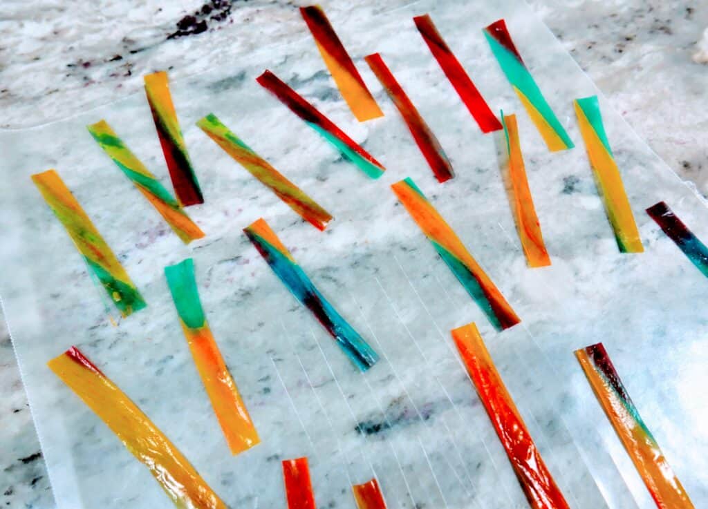 cut strips of tye-dyed fruit by the foot