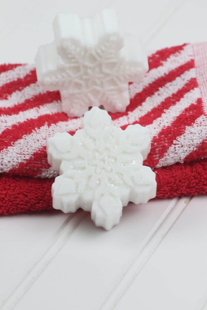 Sparkly Snowflake DIY soap bars on festive towels.