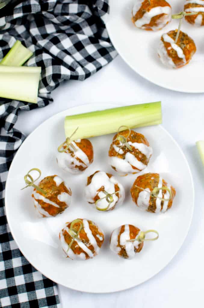 buffalo chicken meatballs on a plate with celery