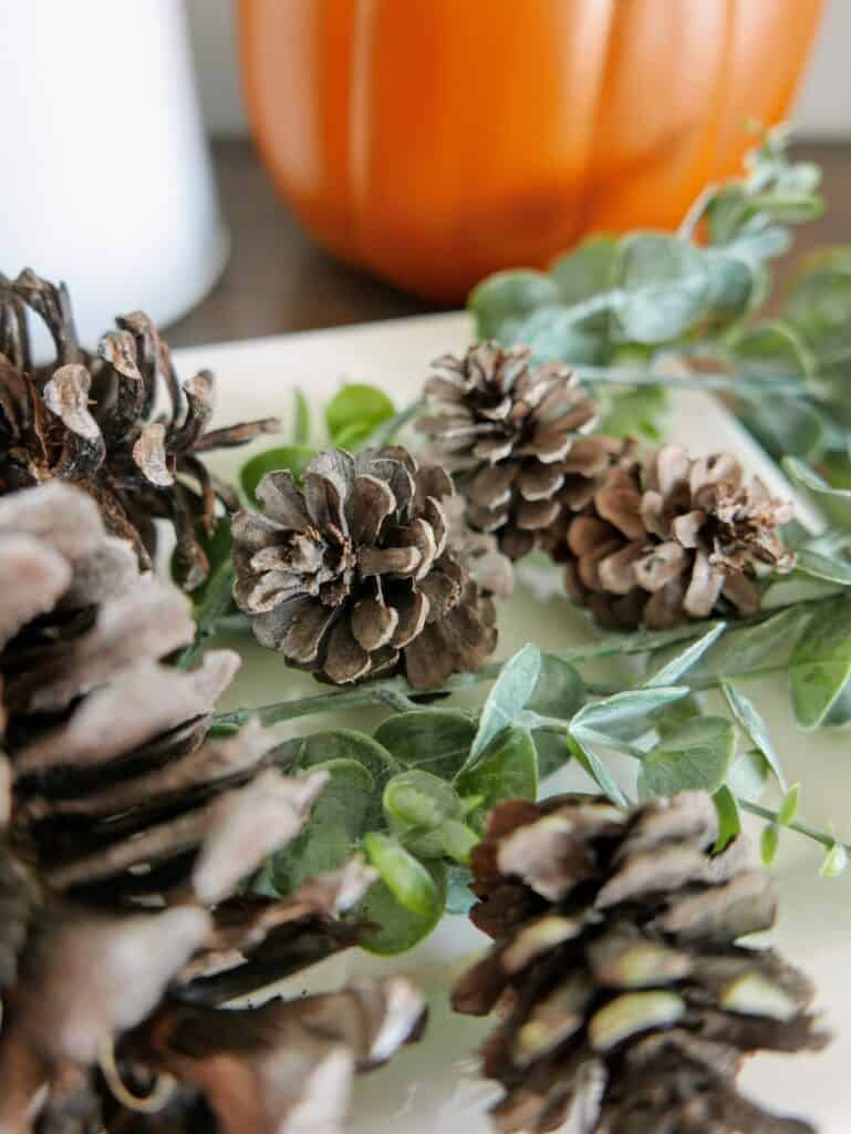 close up of DIY scented pine cones and greenery