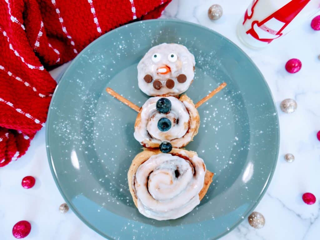 cinnamon roll snowman on a plate