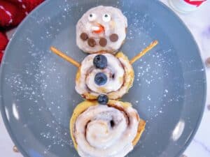 cinnamon roll snowman on a plate