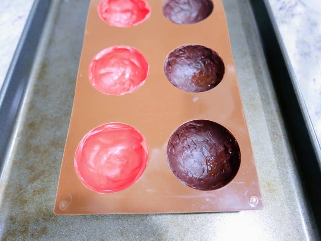 silicone mold pained with both chocolate and candy melts and hardened