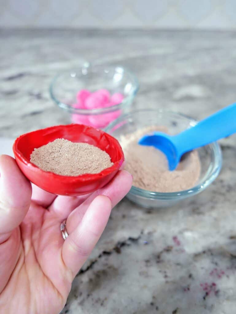filling the candy melt cup with hot chocolate powder