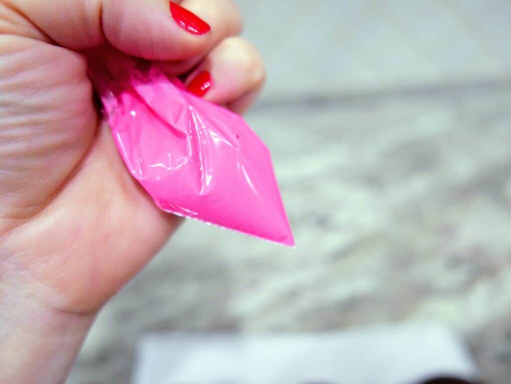 sandwich bag filled with pink candy melts for drizzling