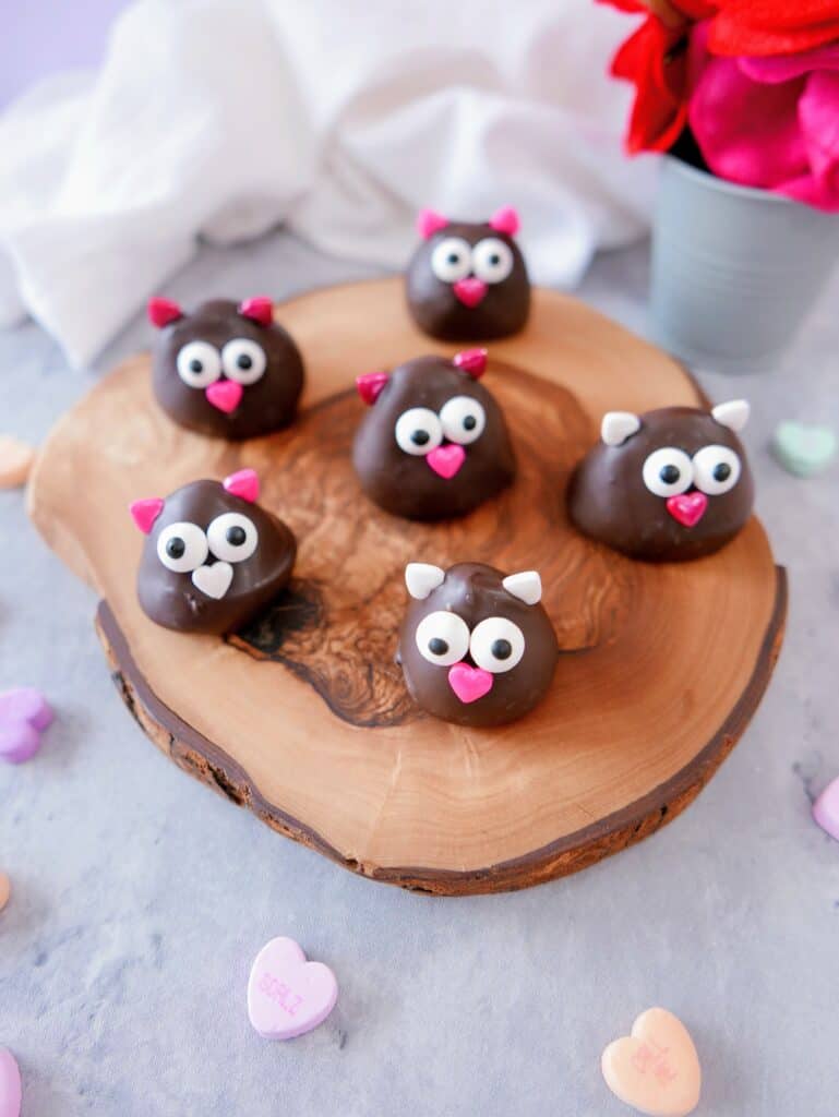 chocolate-covered strawberry lovebirds on a wood tray