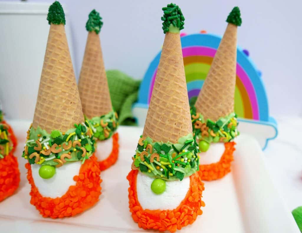 St. Patrick's Day gnomes on a white tray with a rainbow in the background