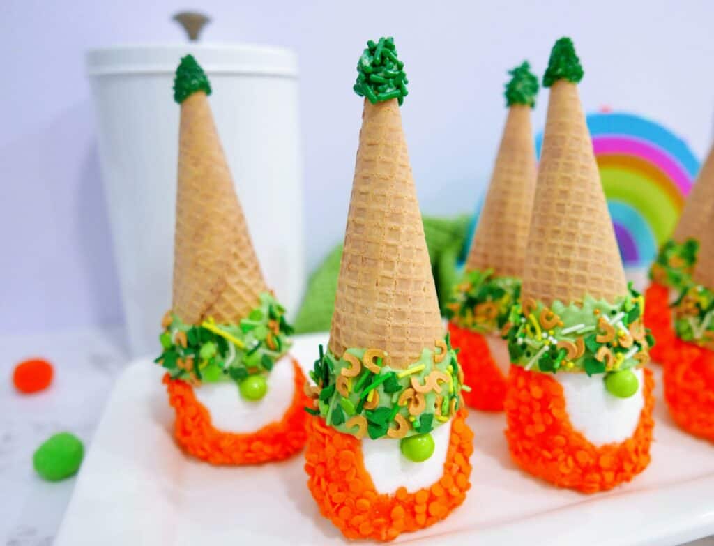 St. Patrick's Day gnomes on a white tray with a rainbow in the background