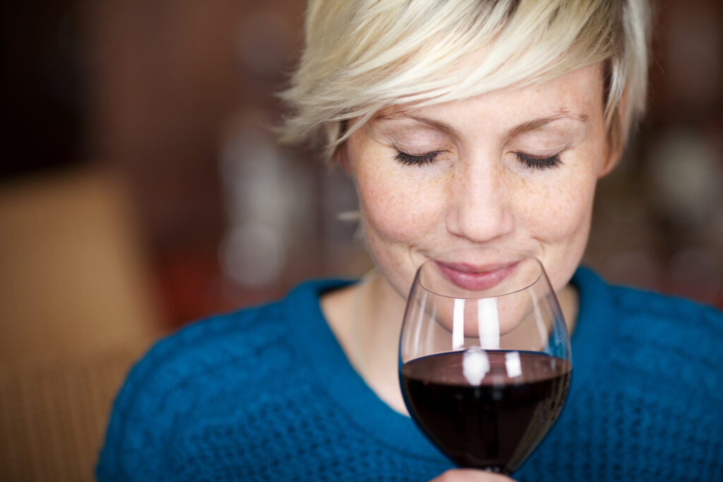 woman sipping a glass of wine