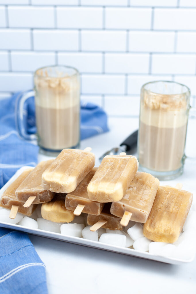 stacked root beer float popsicles on a tray