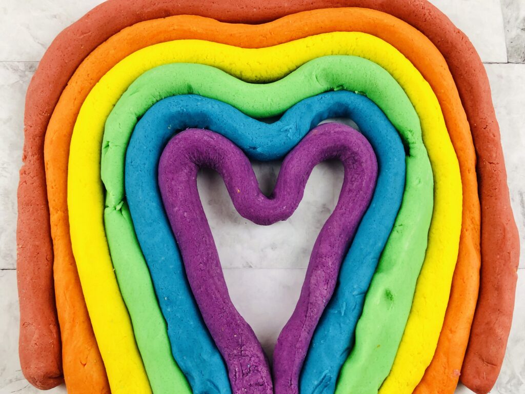 layered heart made out of strips of colored DIY play dough