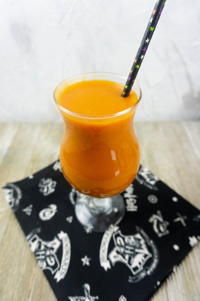 pumpkin juice in a glass with a straw