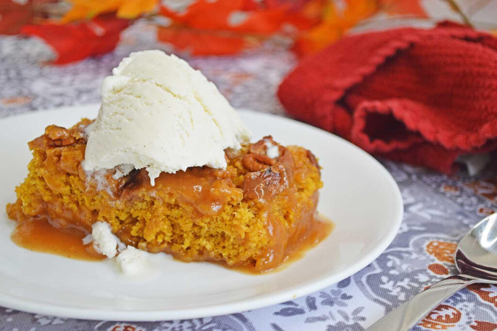 the best pumpkin cobbler on a plate with ice cream