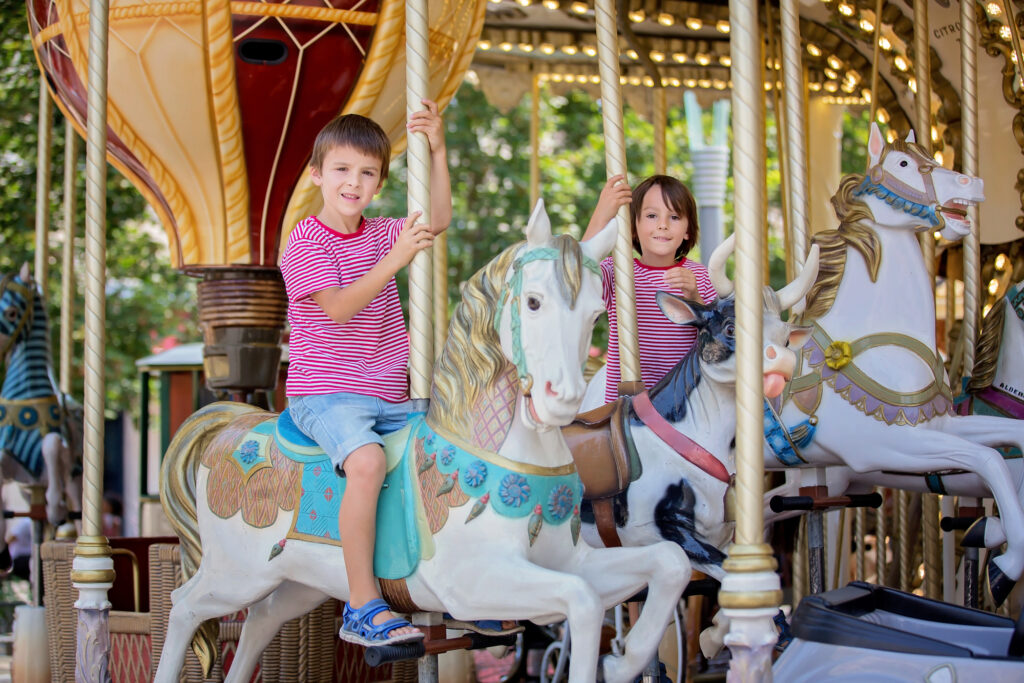 kids riding on horses on the merry go round - kid gifts for horse lovers