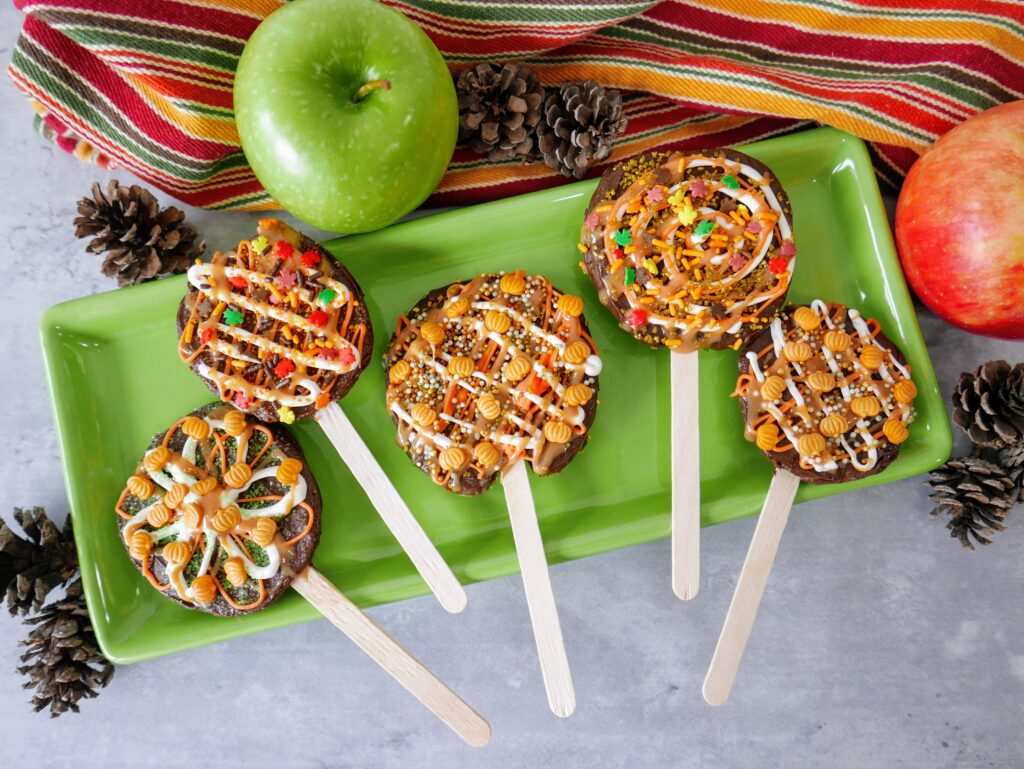 Chocolate caramel apple pops on a tray
