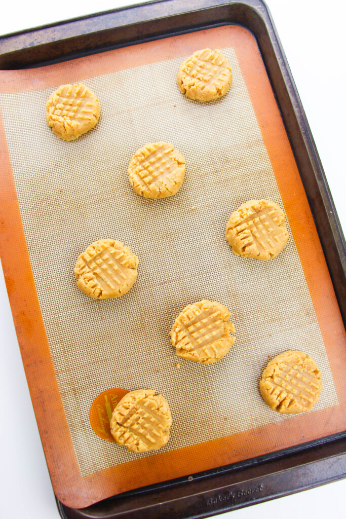 adding fork marks to peanut butter cookies