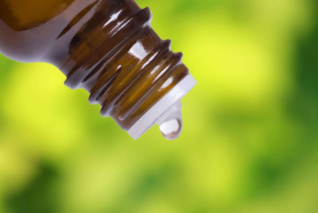essential oil dripping out of bottle