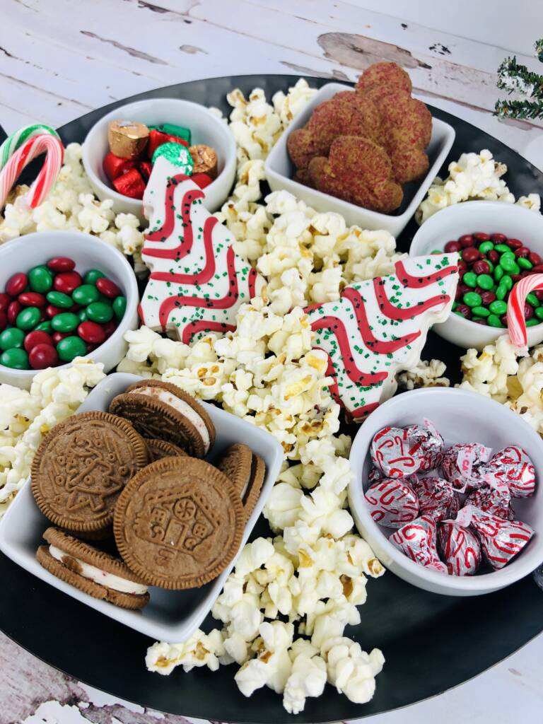 cookies, popcorn, and candies on a tray board