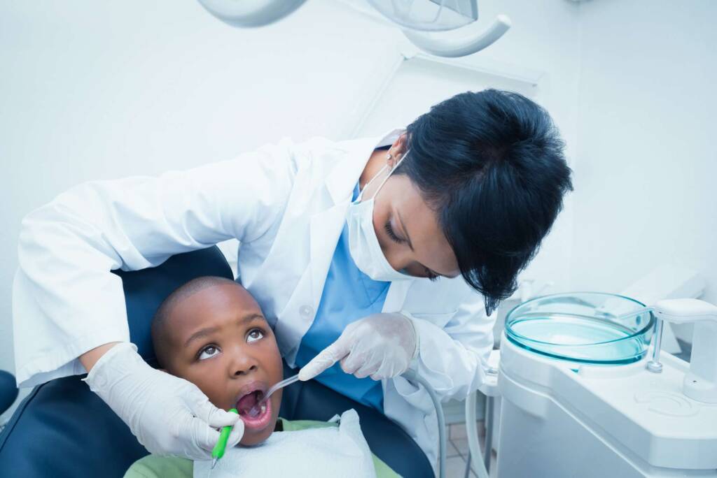 dentist checking child's teeth