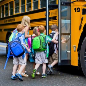 kids getting on the bus as part of their morning routine for school