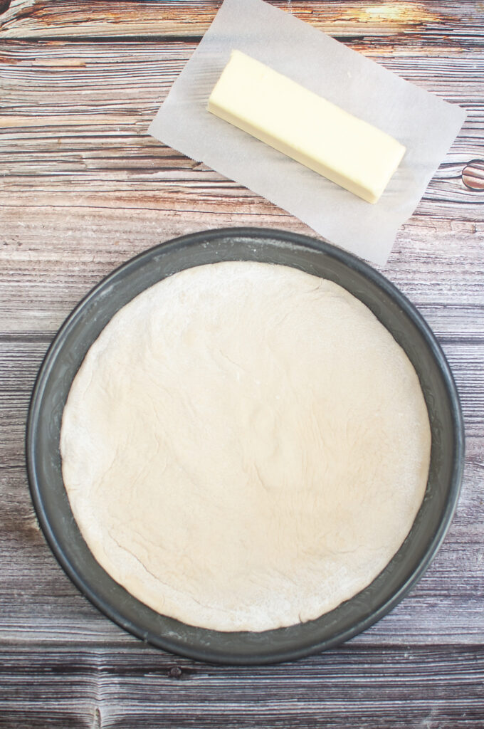 adding dough to pie pan