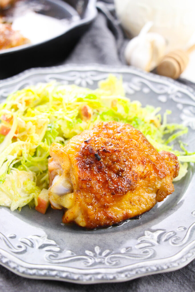 honey mustard chicken thigh on plate with salad