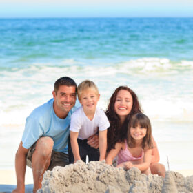 family on the beach building sand castle