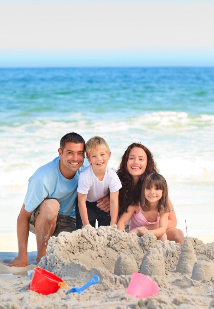 family on the beach building sand castle