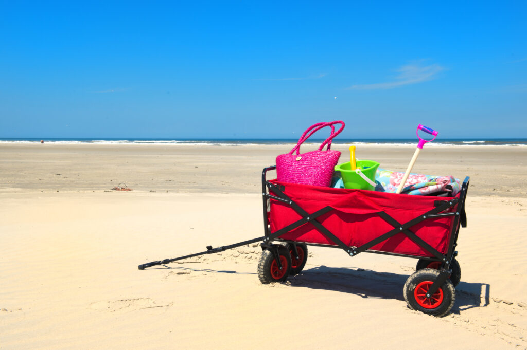 wagon with toys and essentials on the beach