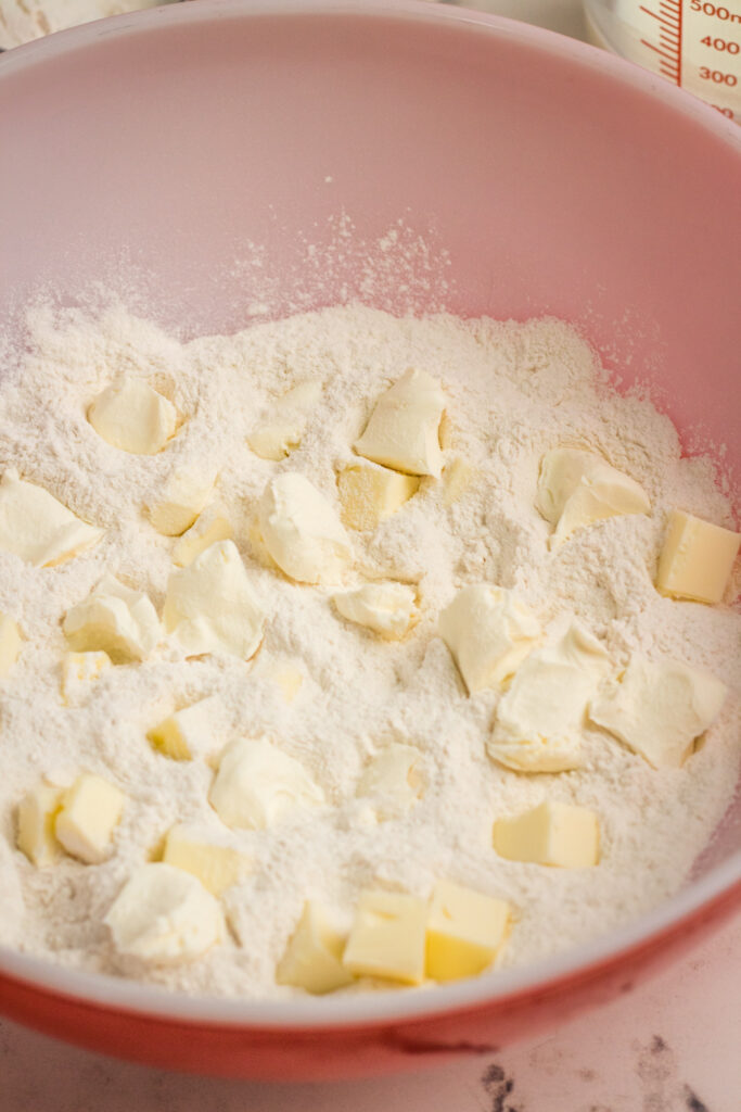 adding cubed butter to flour