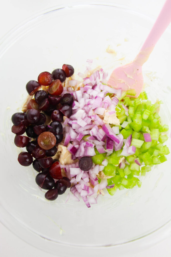 adding celery, grapes, and onion