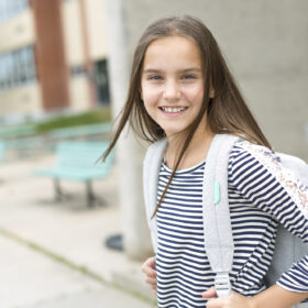 middle school girl wearing backpack