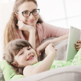 mom and daughter on tablet