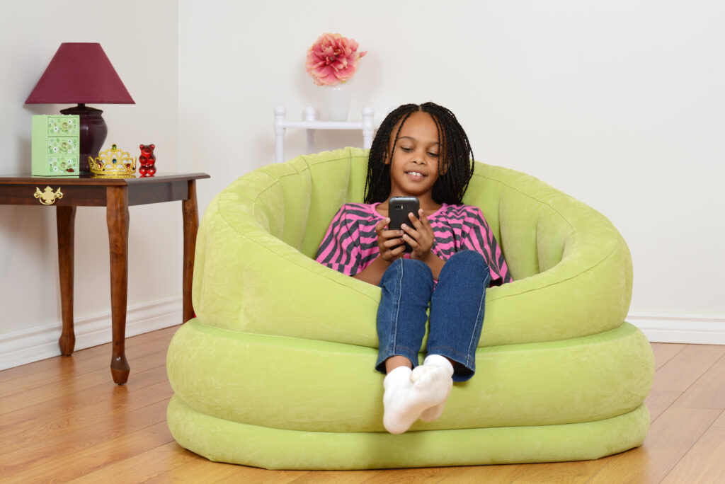 girl in chair on cell phone